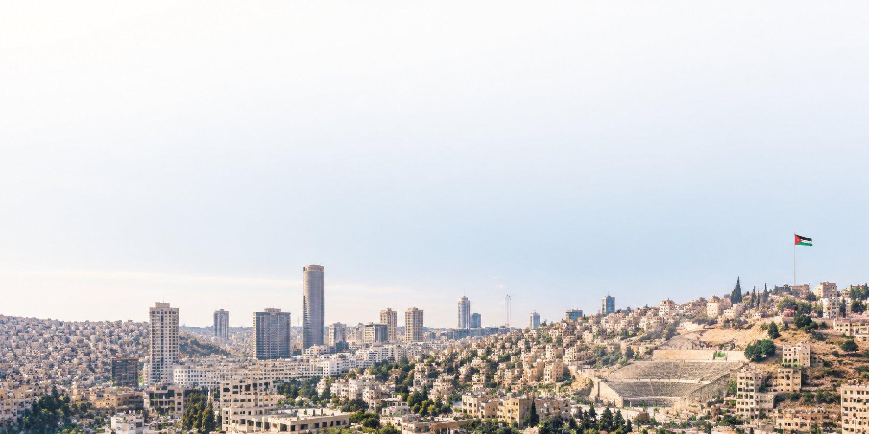 The Amman skyline, with the Roman theatre and the Jordanian flag